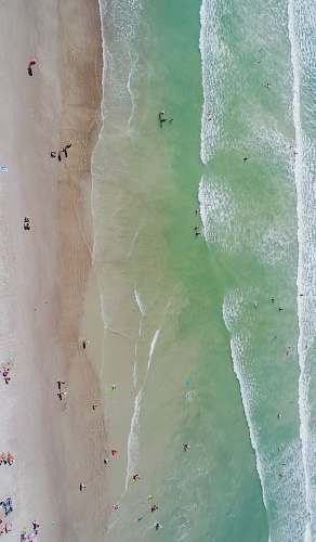 from above people at the beach during daytime aerial photography drone view